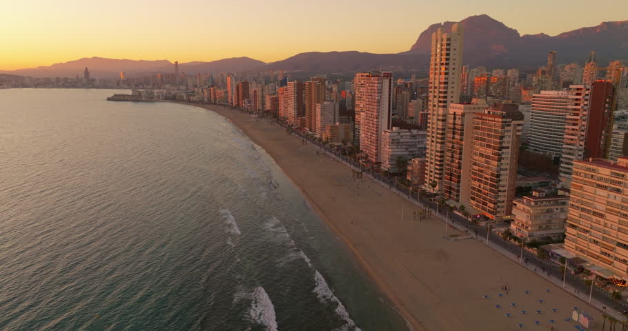 Establishing aerial view of Benidorm skyline skyscrapers hotels and resorts, Benidorm seaside coastline. Aerial view of skyscrapers and beach of the touristic city of Benidorm in the Spain