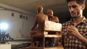 The sculptor is working on a reduced layout of the monument. work with professional clay – Plasticine in scale. 4k video