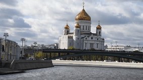 View from sailing tourboat of Russian orthodox Cathedral of Christ the Saviour in a cloudy autumn day in Moscow, Russia. Soft focus. Real time handheld video. Travel in Russia theme.