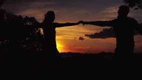 Silhouette, sunset and couple dancing in nature, love and happiness for romance - Powered by Shutterstock - Get 15% off with code: PIKWIZARD15