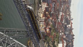 Train on Dom Luis Bridge and Douro river in Porto, Portugal. Vertical video