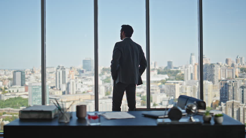 Manager silhouette contemplating city in panoramic office rear view. Calm company ceo in suit thinking looking window alone. Successful professional silhouette dreaming pondering future at workplace. Royalty-Free Stock Footage #3418332609