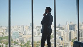 Thoughtful man looking panoramic window in office. Legal manager contemplating city buildings planning company strategy at workplace rear view. Unrecognized silhouette making business decision. - Powered by Shutterstock - Get 15% off with code: PIKWIZARD15