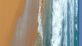 Landscape with ocean waves on the tropical beach. Vertical video