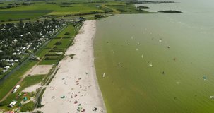 Group of Kitesurfers at the Beach, Forwards - Workum, Friesland, The Netherlands, 4K Drone Footage
