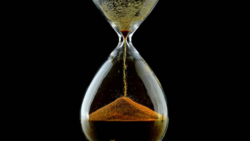 Sand running through hourglass timer with black background. Close up footage of sand time on black background. sand pouring inside an antique transparent hourglass. Time is up Concept. Royalty-Free Stock Footage #3418389481