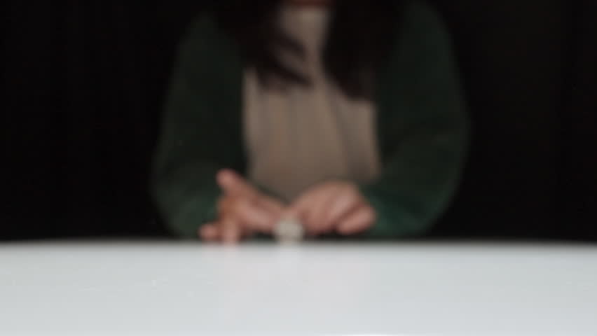 U.S. Quarter Being Flicked And Spinning Past Camera