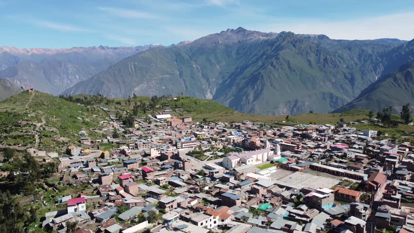 Colca Canyon, Peru: Aerial drone footage of the Cabanaconde town with the colonial San Pedro de Alcantara church in the Colca Canyon in the Andes mountains in Peru in south America