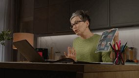 Law angle view of successful pretty mature female executive in eyeglasses video conferencing online using laptop , analyzing financial data with business partners while working from home. - Powered by Shutterstock - Get 15% off with code: PIKWIZARD15