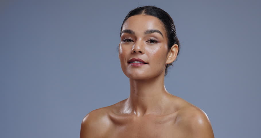 Skincare, wellness and face of woman on blue background laugh with confidence, beauty and cosmetics. Dermatology, aesthetic and portrait of happy person with natural glow and healthy skin in studio