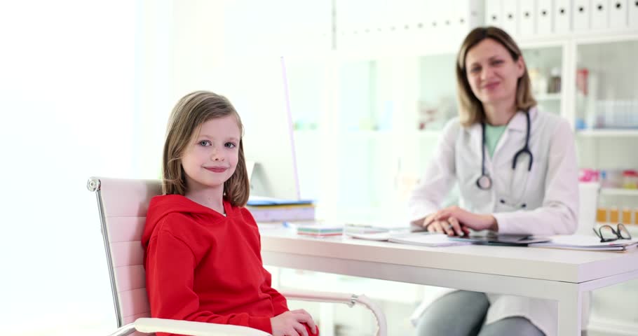 Little girl showing red toy heart at pediatrician doctor appointment 4k movie slow motion. Quality professional medical care for children concept Royalty-Free Stock Footage #3418554499