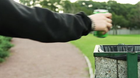 Young Couple Throwing Garbage in Recycling Bin in a Public Park.