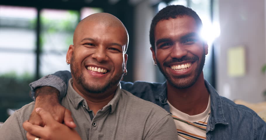 Home, gay couple and happy face with smile and love with bonding and hug in a living room. Partner, men and lgbt pride with marriage together in a house with queer romance and relationship care Royalty-Free Stock Footage #3418577975