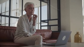 Concerned Senior Woman Adjusting Glasses to Use Laptop - Powered by Shutterstock - Get 15% off with code: PIKWIZARD15