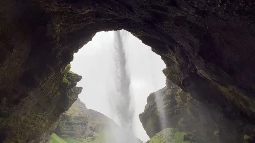 Behind the beautiful Kvernufoss waterfall in a mossy gorge southern Iceland