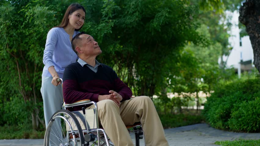 Asian careful caregiver or nurse taking care of the patient in a wheelchair. Concept of happy retirement with care from a caregiver and Savings and senior health insurance, a Happy family Royalty-Free Stock Footage #3418833497