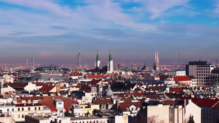 Church towers and modern high rise buildings in background exceeding surrounding buildings in urban borough. Vienna, Austria Royalty-Free Stock Footage #3418880485