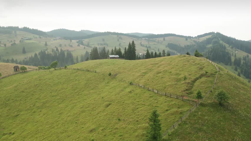 Summer morning in Bucovina. Aerial 4K video over folk scenery mountain hills villages in the north part of Romania, next to Neamt and Suceava.