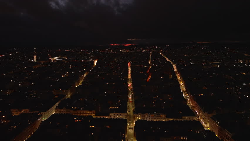 Aerial night view of city. Illuminated streets and blocks of buildings in urban borough. Vienna, Austria