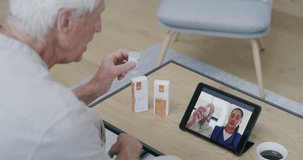 Home, video call and old man with tablet, medicine and conversation with internet, help and checkup. Pensioner, technology or nurse with advice, healthcare and online consultation with pills or app