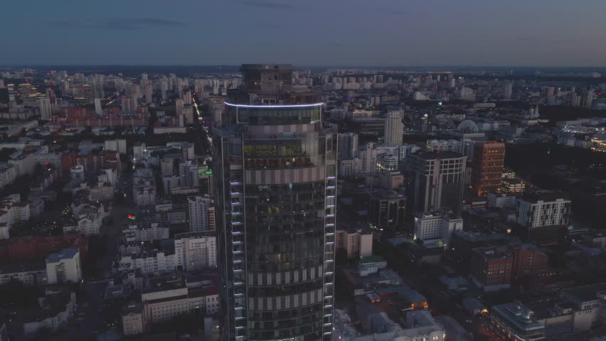 Evening aerial view Yekaterinburg center metropolis. Metropolis Yekaterinburg blend of skyscrapers Ural heritage Metropolis urban architecture Cityscape sparkles capturing essence of Russia
