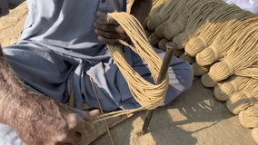 Hand Made Ropes In Pakistan. making ropes with hand for sleeping bed known as charpai in Pakistan. Different achievements of knot and assembly of boat ropes. Man is becoming a ropes. 4K Footage.