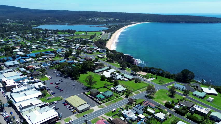 Drone aerial over residential housing and commercial shops holiday town street roads Aslings Beach Twofold Bay Eden South Coast Australia Royalty-Free Stock Footage #3419013697