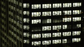 Close up shot of exterior of office building window at night. Company, corporate, job, work and business people concept video.