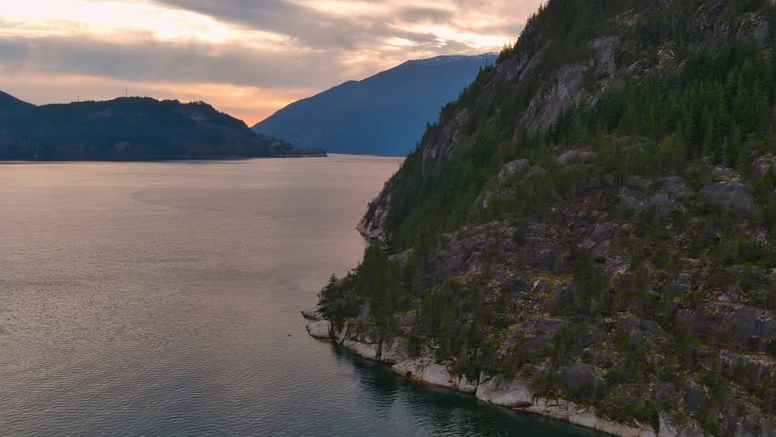 Scenic Ocean Coast and Mountains in Howe Sound. Cloudy Sunset Sky, Fall Season. Howe Sound, British Columbia Canada. Royalty-Free Stock Footage #3419051155