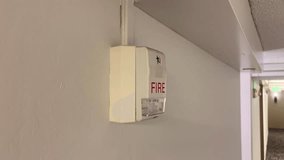 Fire Alarm and Green Exit Sign in Building Corridor - Powered by Shutterstock - Get 15% off with code: PIKWIZARD15