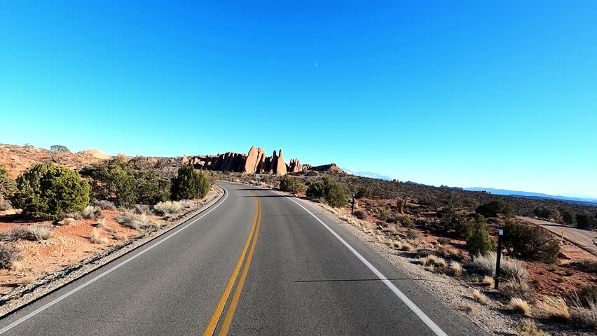 You have a front seat view driving into the Arches National Park as you explore the stunning rock formations, vast canyons, and sweeping landscape views.