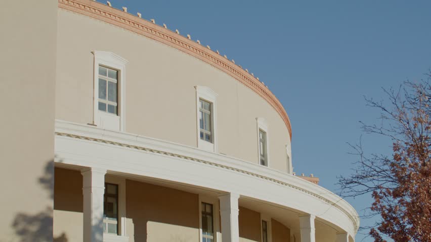 Exterior of New Mexico State capitol building in Santa Fe, New Mexico with video tilting down.
