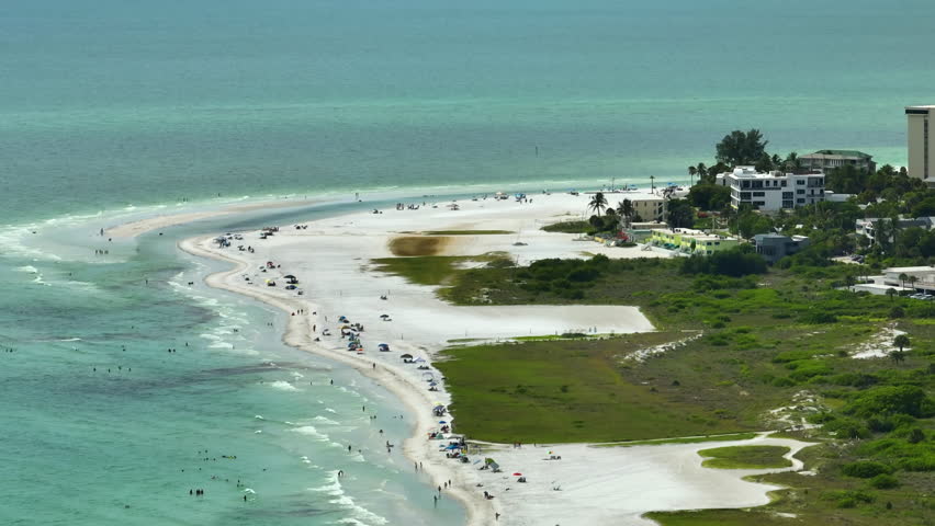 Hotel buildings in front of famous Siesta Key beach with soft white sand in Sarasota, USA on summer sunny day. Popular vacation spot in warm Florida