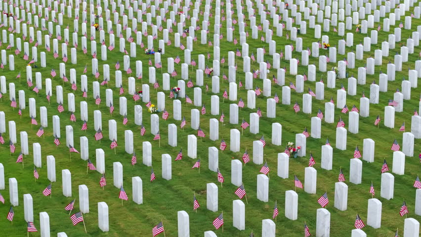 Large american army national cemetery with rows of white tombstones on green grass. Memorial Day concept