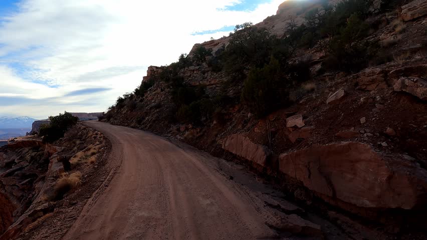 Driver Seat POV. Embark on an epic off-road adventure through Utah’s rugged terrain as you explore the stunning vistas and sweeping red rock canyons of Shafer Trail. Royalty-Free Stock Footage #3419187949