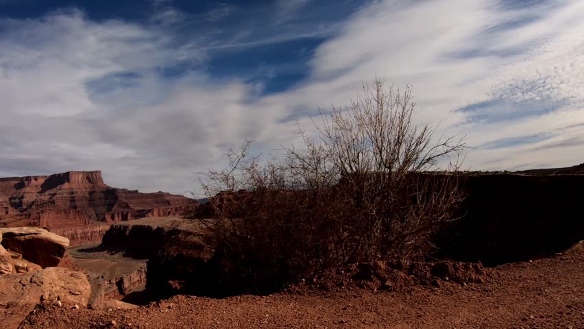 A side view looking down into a very deep canyon from the shelf road above.
