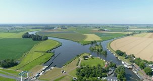 Colorful Flat Fields Next to a Sluice with Recreational Boats - Friesland, The Netherlands, 4K Drone Footage

