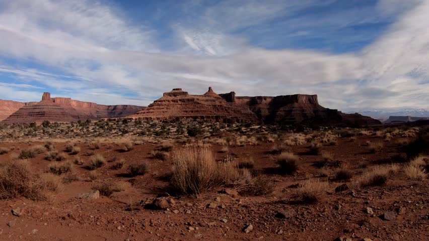 A side view discovering the hidden gems of Utah’s White Rim Trail as you drive through stunning vistas and rugged terrain Royalty-Free Stock Footage #3419198341