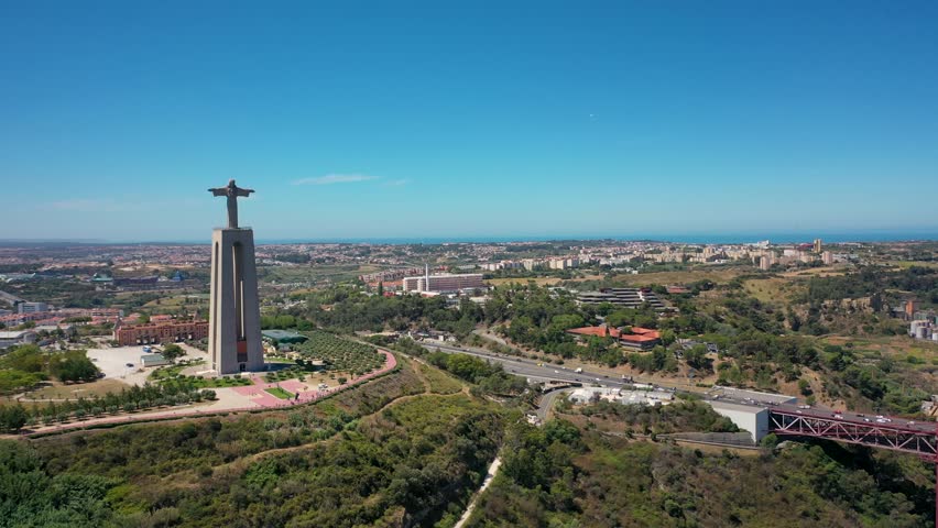 Aerial 4K video from drone to Sanctuary of Christ the King in Portuguese Santuario de Cristo Rei-Monument in Lisbon,Portugal,Europe.Catholic Statue with Jesus Christ in Almada near 25 de Abril bridge 