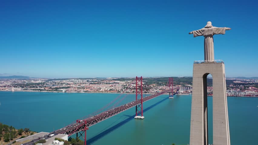 Aerial 4K video from drone to Sanctuary of Christ the King in Portuguese Santuario de Cristo Rei-Monument in Lisbon,Portugal,Europe.Catholic Statue with Jesus Christ in Almada near 25 de Abril bridge 
