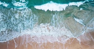 Aerial view video Top-down view beach with sea wave foamy texture water surface beautiful ProRes422