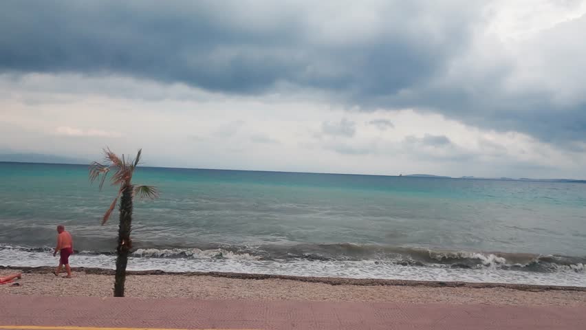Corfu, Greece - 15 Sep, 2023: Driving along beach in Corfu island in Greece