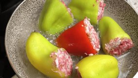 Preparing stuffed peppers. Stuffed peppers are cooked in a frying pan. Step-by-step cooking video recipe. Cooking master class.