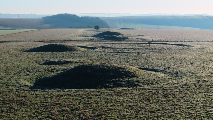 Telephoto aerial shot of Bronze age burial mounds in English countryside