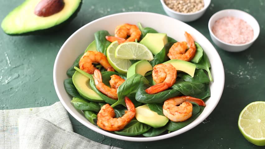 Salad with shrimps, avocado, spinach and almonds. Healthy eating. Diet.