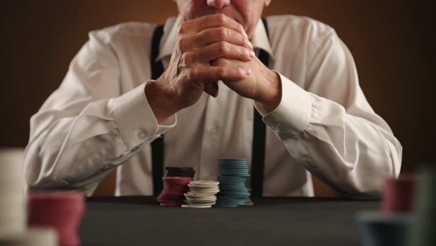 With a determined move, a poker player pushes his chips forward for an all-in wager, a high-stakes moment of risking everything in the game. Camera 8K RAW.
