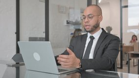 Mixed Race Businessman Chatting Online on Laptop while Sitting