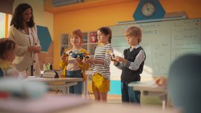 Team of Kids Presenting a Science Project. Talented Boy and Two Girls Created a Functioning Cyborg Hand. Primary School Classroom with Gifted Brilliant Children Working on Futuristic Technology - Powered by Shutterstock - Get 15% off with code: PIKWIZARD15