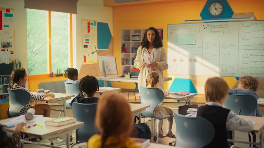 Elementary Classroom with Diverse Children Listening to the Teacher Asking a Question. Everyone Raising Hands in Order to Provide a Correct Answer. Bright Kids in School Learning Exact Sciences