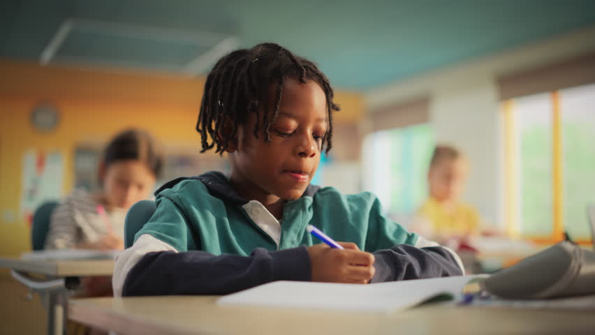 Talented Small African American Boy Asking Teacher a Question in Class. Portrait of a Happy Elementary School Student Studying Hard, Learning New Things, Getting Modern Education with Other Kids Royalty-Free Stock Footage #3419488809